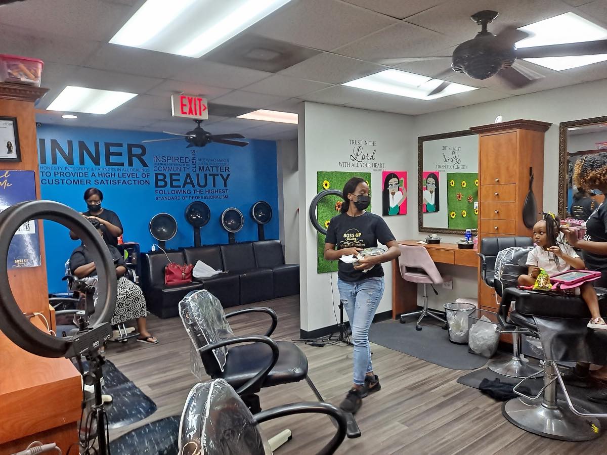 Inside Inner Beauty Salon and Spa, with its branded blue wall and stylists at work