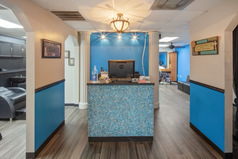 The salon reception desk with mosaic tile and chandelier